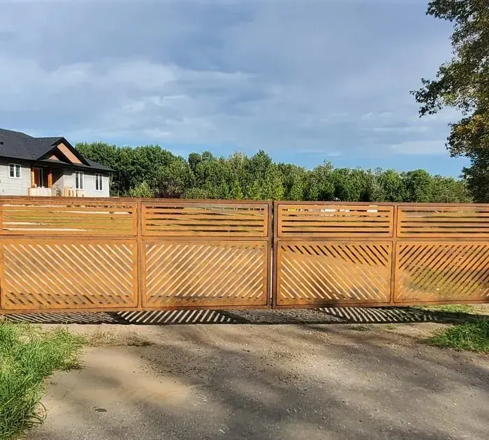 Corten steel gate with slatted top and diagonal-cut lower panels