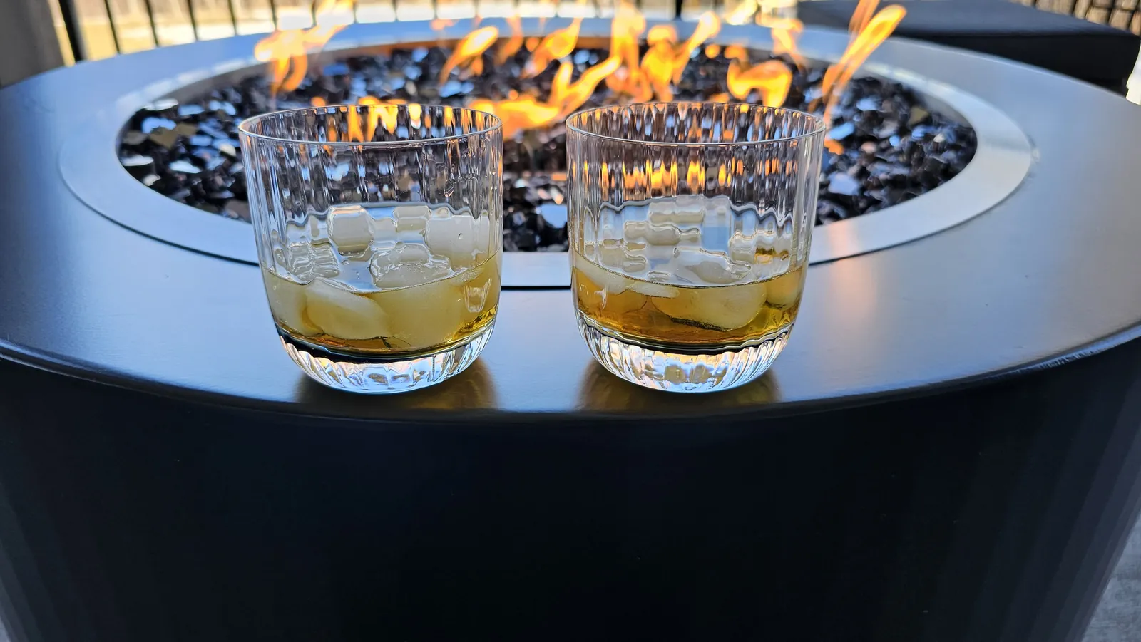 Evening drinks beside a custom steel fire table