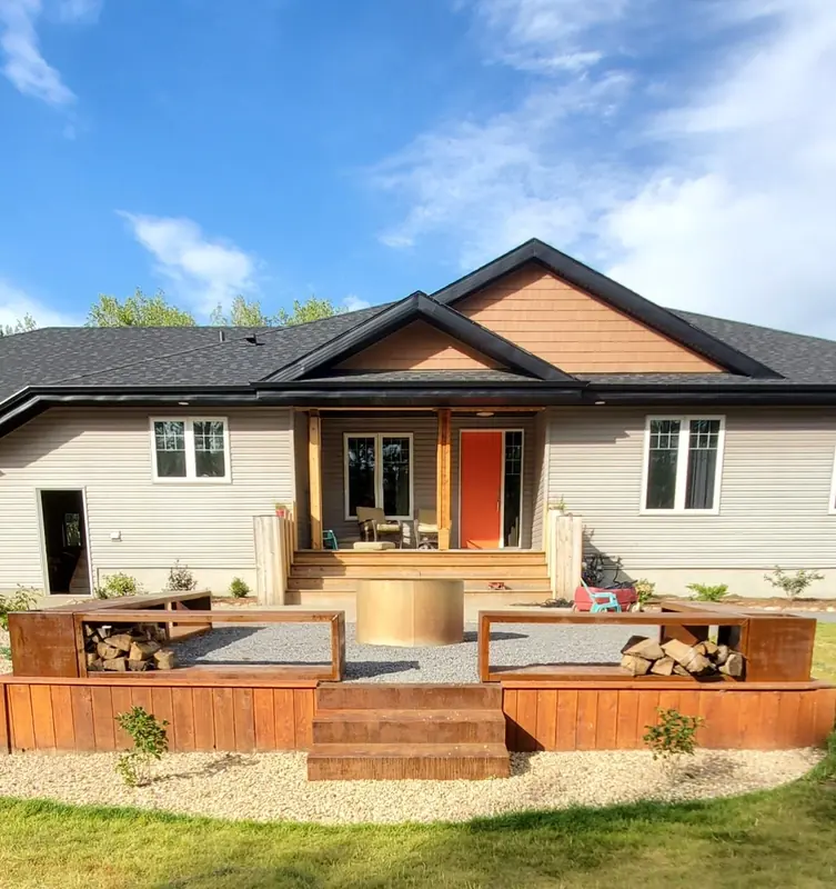 Symmetrical Corten steel firewood benches flanking a round fire pit with a cedar base