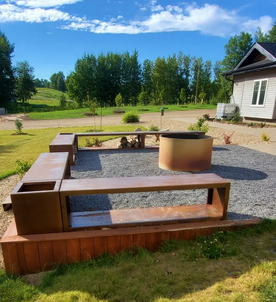 Corten steel firewood bench seating with built-in firewood storage and a round fire pit