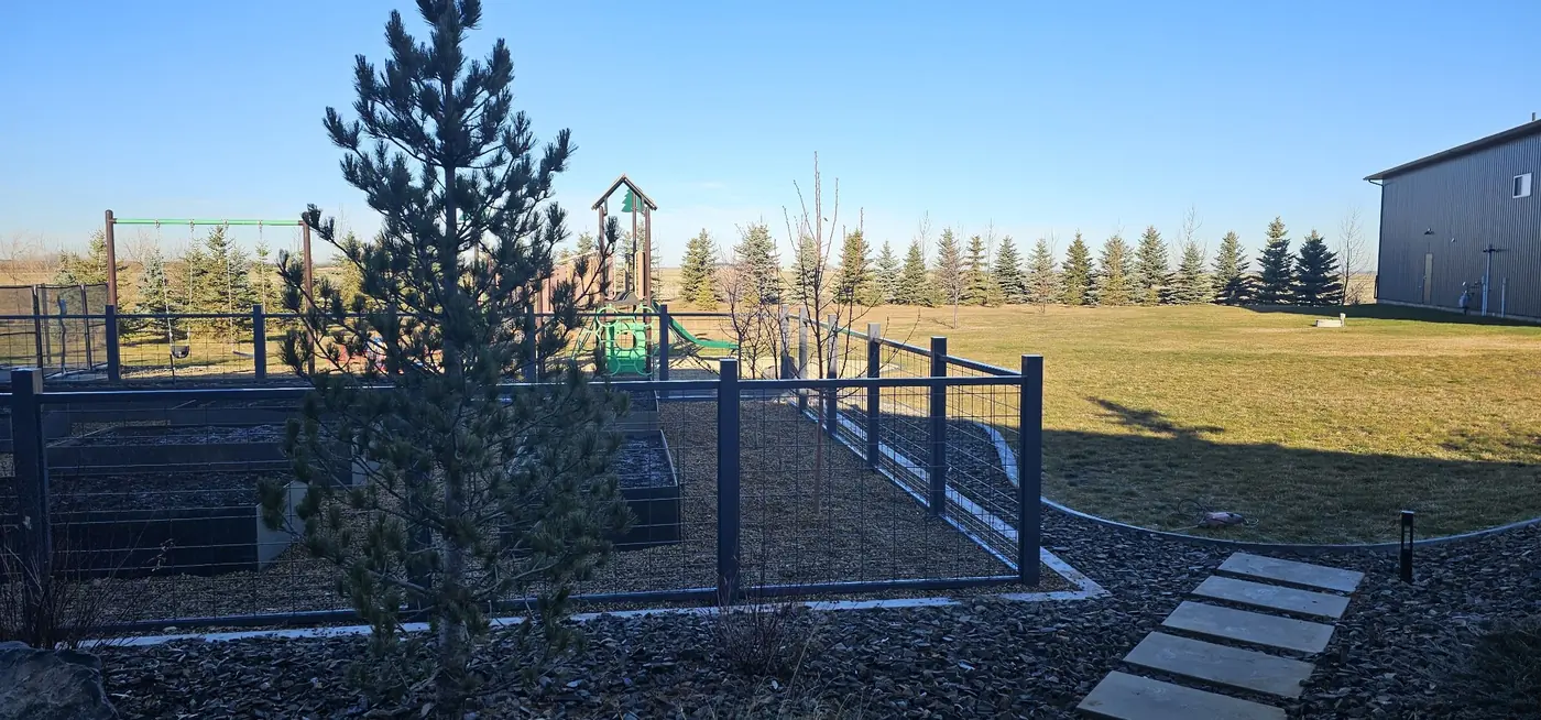 Custom garden fence and gate around a raised-bed garden