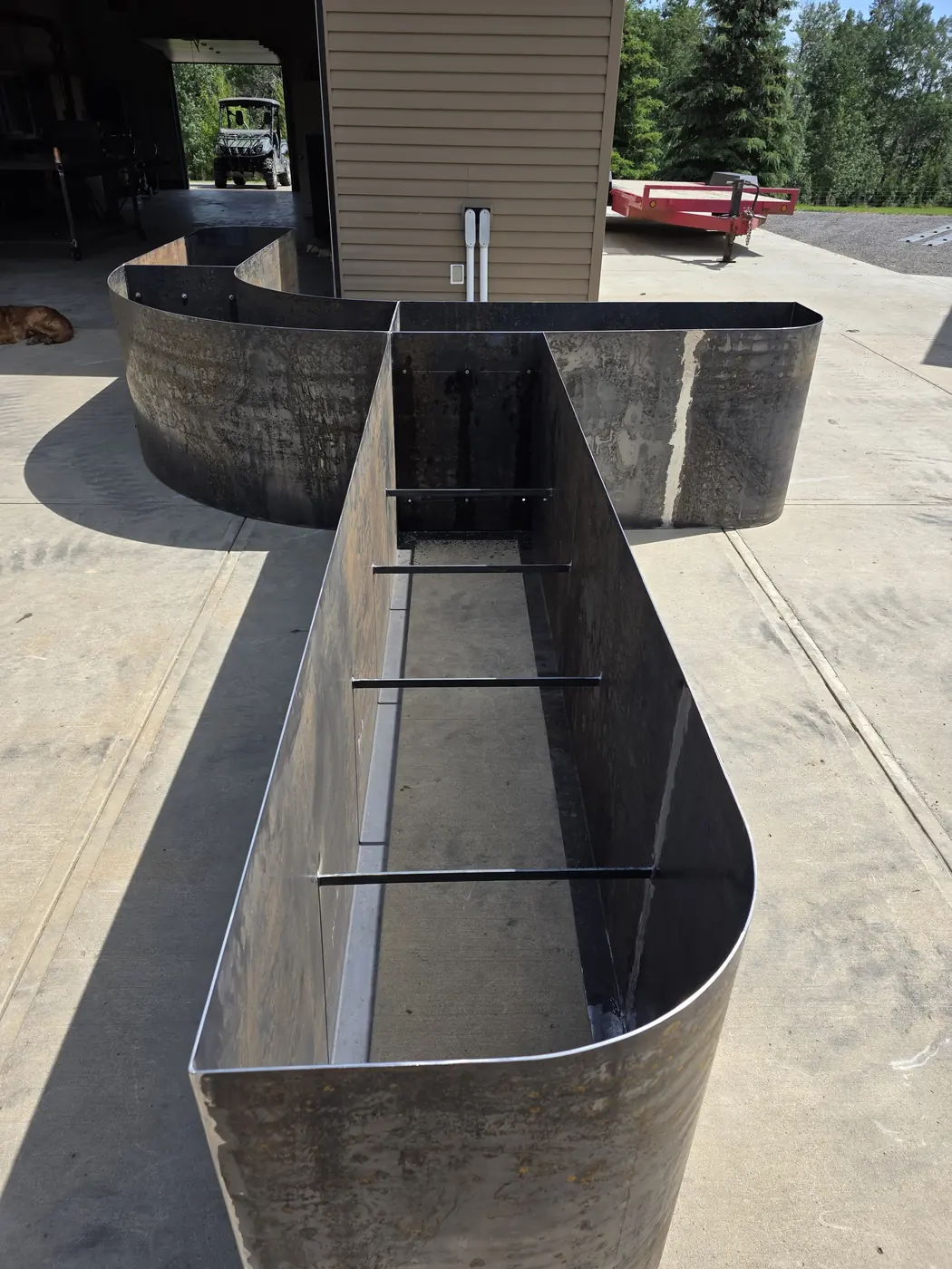 Close view of a Corten steel planter trough with integrated bench shelf