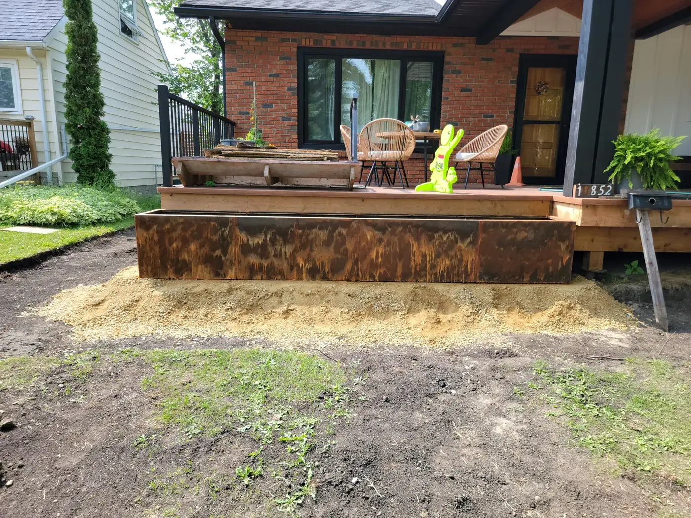 Long Corten planter running the length of the raised deck
